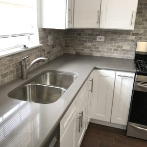 new kitchen remodeling with stone kitchen backsplash and new counter tops