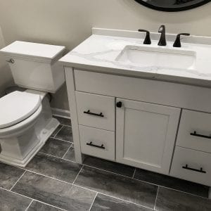 Bathroom Remodeling in Hinsdale - new flooring white and black cabinets and sink