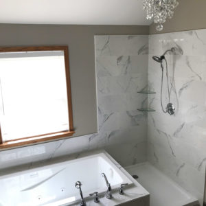 Bathroom Remodeling in Bartlett Illinois: a renovated bathroom with new tub, faucets, cabinets, countertop and more.