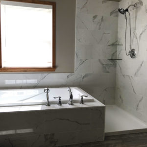 Bathroom Remodeling in Bartlett Illinois: a renovated bathroom with new tub, faucets, cabinets, countertops.